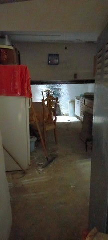 Interior view of a rustic cave house in Cortes de Baza, Granada, showing wooden furniture and natura.
