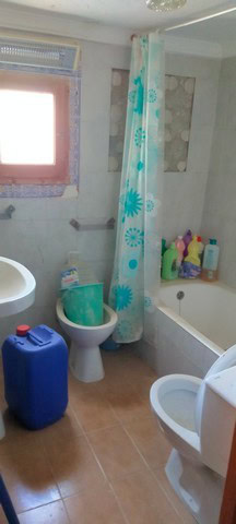 Charming cave house interior in Cortes de Baza, Granada, featuring a bathroom with a bathtub, toilet.