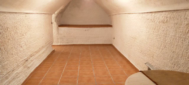 Cave house interior in Benamaurel, Granada, showcasing traditional underground living space.