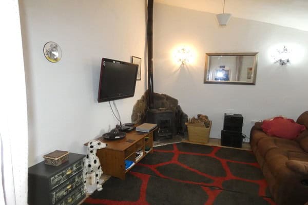 Charming interior of a village property in Gor, Granada, featuring a living room with a fireplace, T.