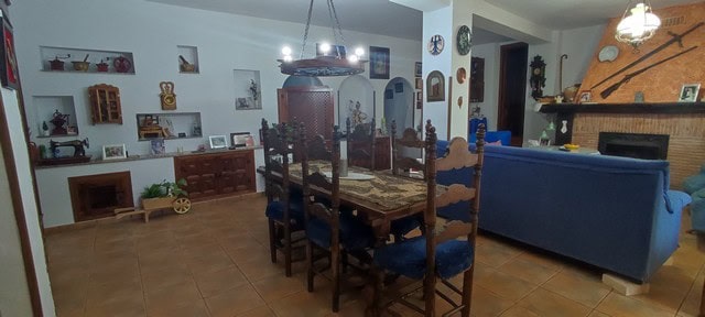Charming cave house interior in Caniles, Granada, featuring a cozy dining area and traditional decor.
