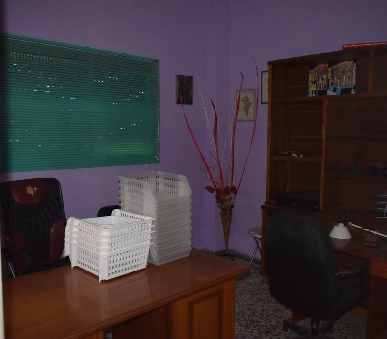 Cozy apartment interior in Baza, Granada, featuring a workspace and storage area.
