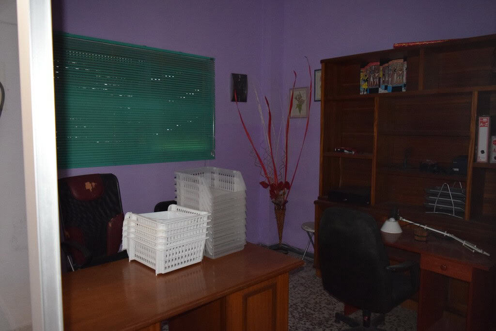 Cozy apartment interior in Baza, Granada, featuring a workspace and storage area.