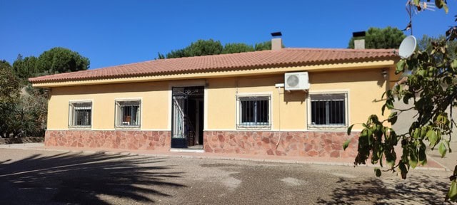 Charming villa in Armuna, Almeria with a warm yellow exterior and secure window bars. Perfect for co.