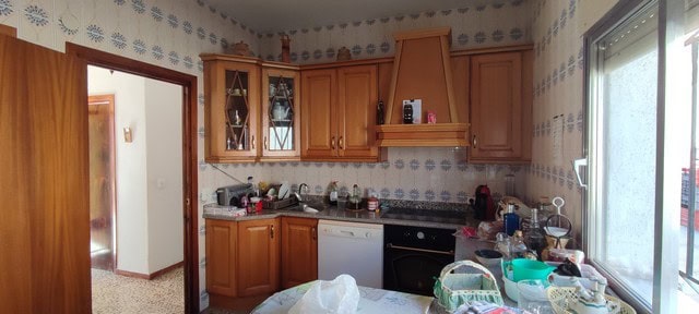 Cozy kitchen in a villa located in Armuna, Almeria, featuring wooden cabinets and modern appliances.