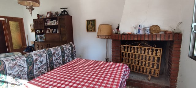 Cozy living room with traditional fireplace and vintage decor in a villa located in Armuna, Almeria.