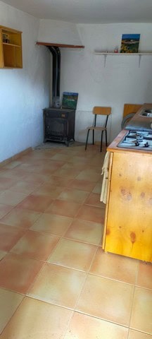 Interior view of a rustic kitchen in a rural property in Seron, Almeria, featuring a wood stove, sim.