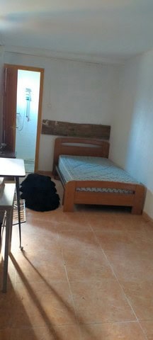 Charming rural bedroom in Seron, Almeria with simple furnishings and natural light.