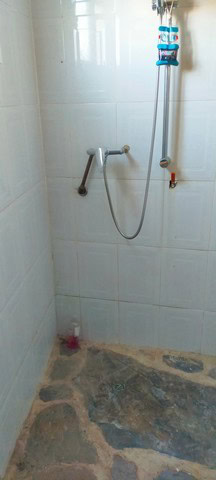 Shower area in a rural property in Seron, Almeria with basic fixtures and stone flooring.