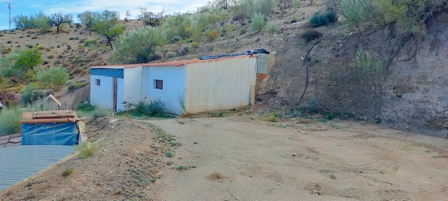 Rural property in Seron, Almeria with simple structures and scenic landscape.