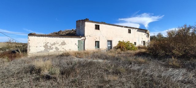 Rural property for sale in Valcabra, Granada, featuring a traditional Spanish farmhouse with surroun.