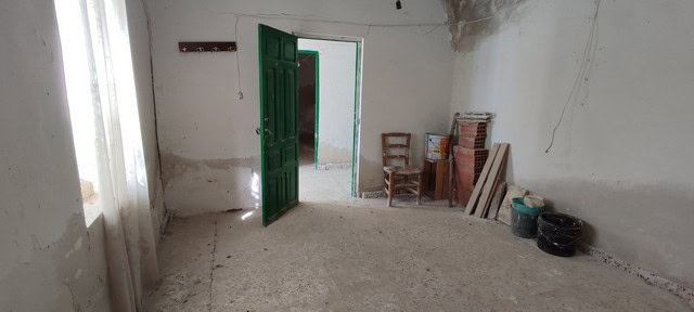 Spacious interior of a rural property in Valcabra, Granada, showing unfinished walls and constructio.