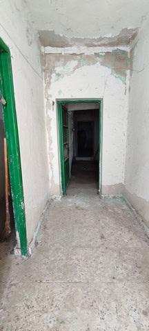 Rural property interior in Valcabra, Granada, with unfinished walls and doorways.