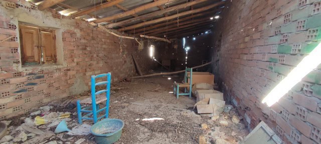 Interior view of a rustic rural property in Valcabra, Granada, showing an unfinished brick interior.