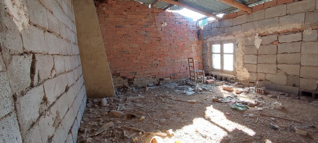 Interior view of an unfinished rural property in Valcabra, Granada, showing exposed brick walls and.