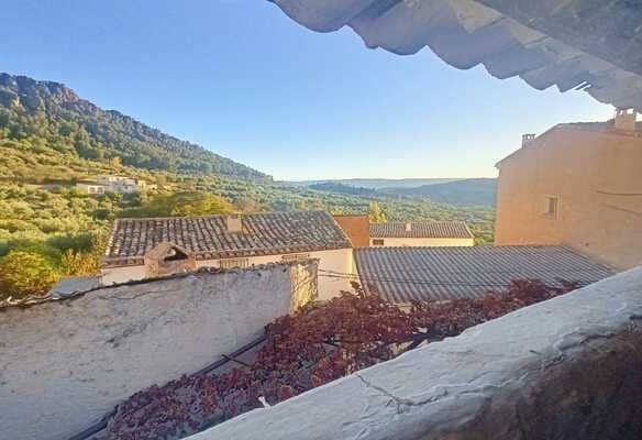 Charming rural property view in Don Pedro, Jaen with scenic mountain landscape and traditional villa.