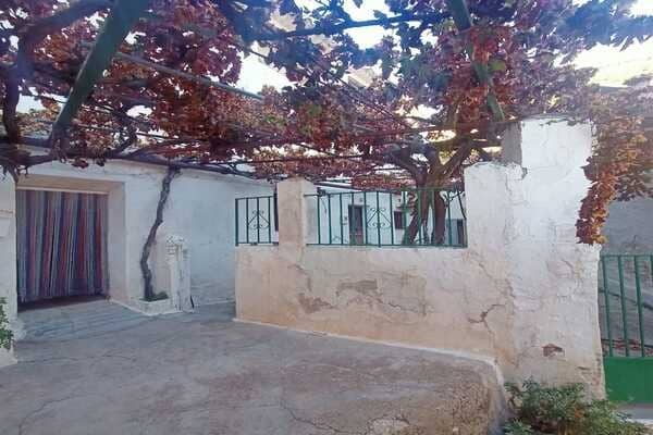 Rustic rural property with a shaded outdoor area in Don Pedro, Jaen, ideal for countryside living.