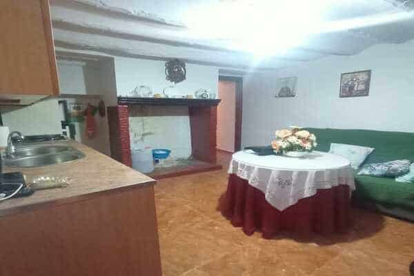 Charming interior of a rural property in Don Pedro, Jaen, featuring a living area with a fireplace,.