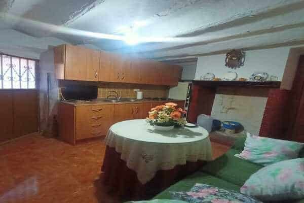 Charming interior of a rural property in Don Pedro, Jaen, featuring a simple kitchen and living area.