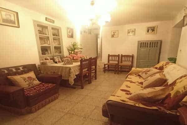 Cozy living room of rural property in Don Pedro, Jaen, featuring traditional furniture and warm ambi.
