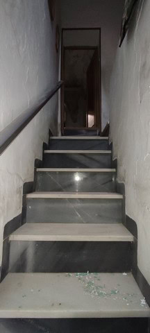 Interior staircase of a town house in Tijola, Almeria, showing worn steps and simple design.