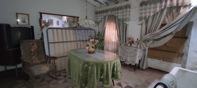 Cozy living room with vintage furniture and floral decor in Tijola, Almeria.