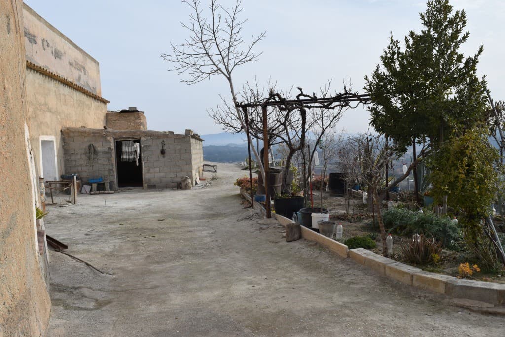 Unique cave house in Benamaurel, Granada, surrounded by natural landscape and rustic outdoor space.