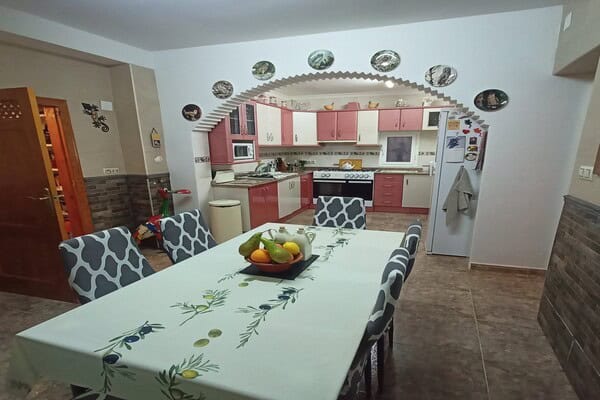 Charming village home kitchen in Hinojares, Jaen with modern appliances and cozy dining area.