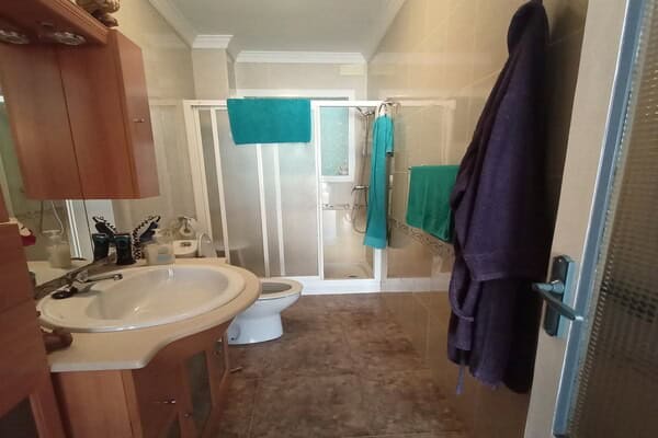 Bathroom with shower, sink, and toilet in village home in Hinojares, Jaen.