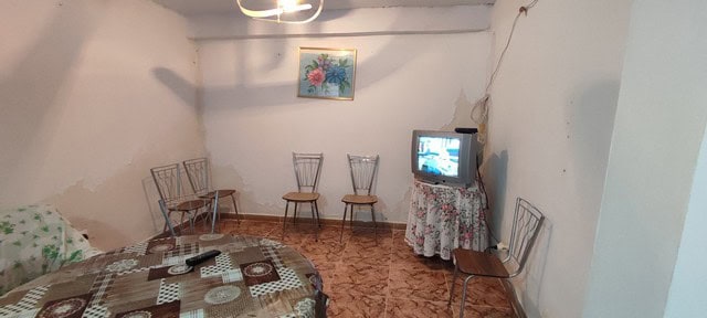 Interior of a rustic village home in Seron, Almeria, featuring a simple living room with chairs, a s.