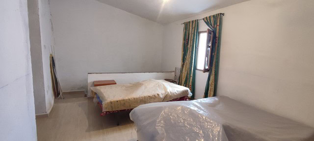 Spacious bedroom in a village property located in Seron, Almeria, featuring simple furnishings and n.