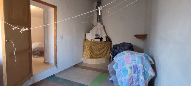 Interior view of a rustic village property in Seron, Almeria, showing simple furnishings and a cozy,.