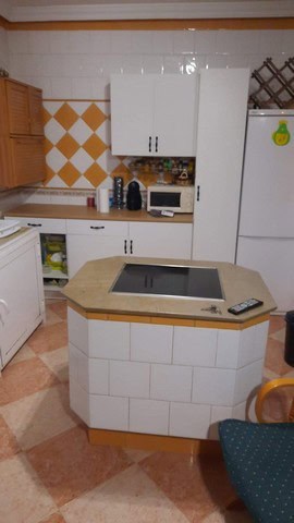 Cozy kitchen in a villa located in Fines, Almeria, featuring white cabinets, a microwave, and a tile.