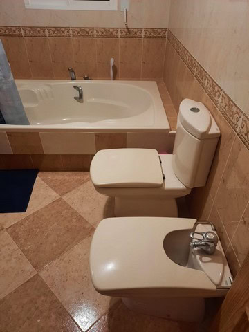 Bathroom with bathtub and toilet in a villa in Fines, Almeria, Spain.