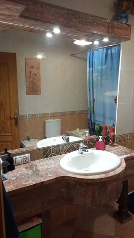Bright bathroom with sink and mirror in Fines, Almeria villa.