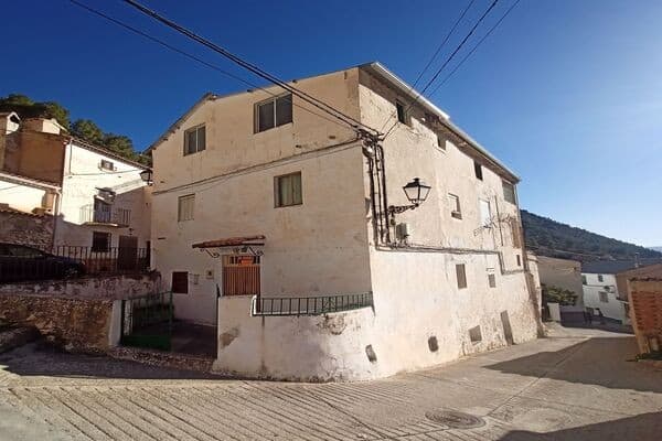 Rural property in Don Pedro, Jaen, featuring traditional architecture and scenic mountain views.