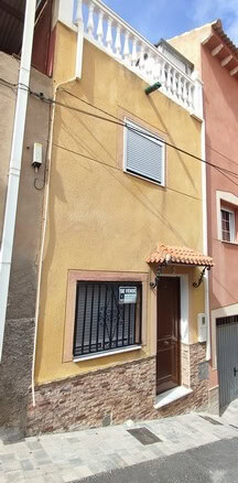 Cozy town house in Tijola, Almeria with traditional architecture and vibrant exterior.