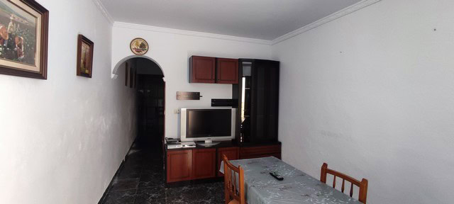 Interior view of a town house in Tijola, Almeria, showcasing a cozy living room with basic furnishin.