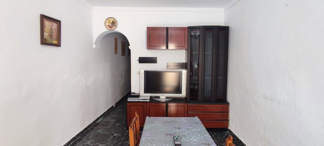 Cozy living room with TV and wooden furniture in Tijola, Almeria.