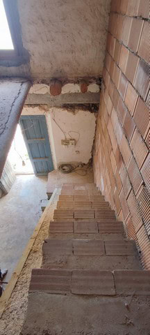 Rural property in Jamula, Granada with traditional brick walls and scenic surroundings.