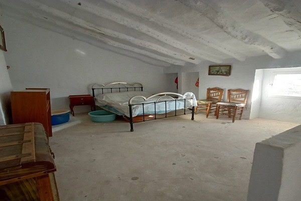 Spacious interior of a rural property in Don Pedro, Jaen, featuring simple furnishings and natural l.