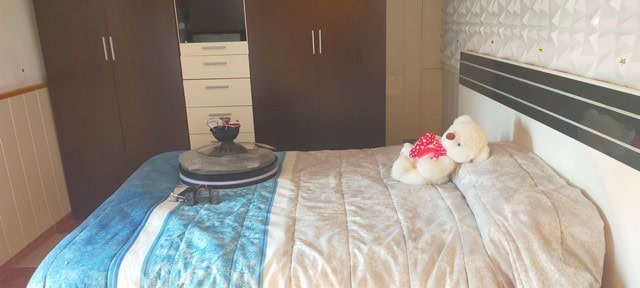 Charming village home in Benamaurel, Granada, featuring a cozy bedroom with plush toys and modern fu.