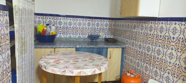 Charming village property kitchen in Benamaurel, Granada with traditional tiles and cozy atmosphere.