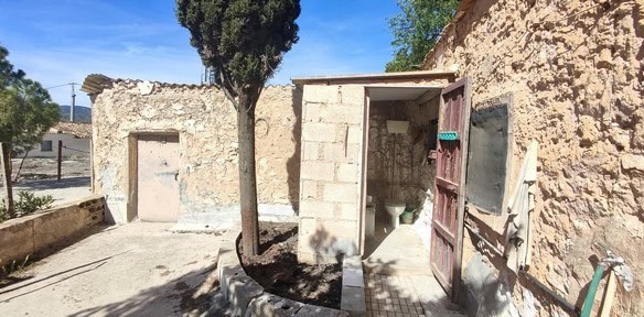 Rural property in Seron, Almeria with stone walls and a small entrance door.