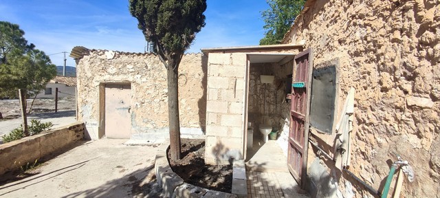 Rural property in Seron, Almeria with stone walls and a small entrance door.