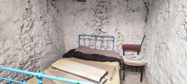 Rustic bedroom with simple furnishings in a stone-walled rural property in Seron, Almeria.