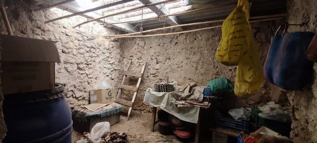 Traditional rural storage in Seron, Almeria, with stone walls and basic furnishings.