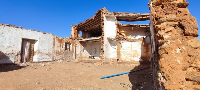 Ruin in Rejano, Granada with weathered walls and exposed structure.