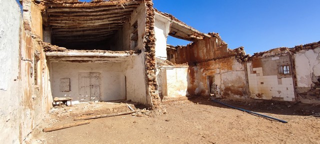 Ruin in Rejano, Granada, showcasing historic stone walls and partially collapsed structures.