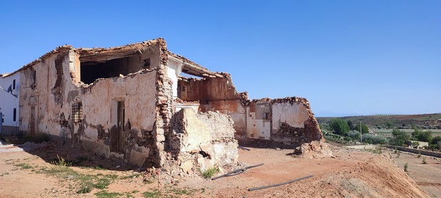 Ancient stone ruin in Rejano, Granada, showcasing historical architecture and scenic rural surroundi.